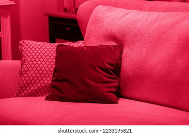 Image toned in pantone color of year 2023 viva magenta. cushions on cozy red sofa. Pillows on casual couch in the living room - Shutterstock ID 2233195821