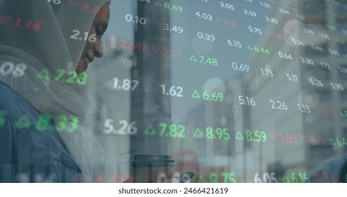 Image of trading board, biracial woman wearing hijab holding coffee and scrolling on cellphone. Graphs, digital composite, report, business, beverage, stock market, drink and technology. - Powered by Shutterstock