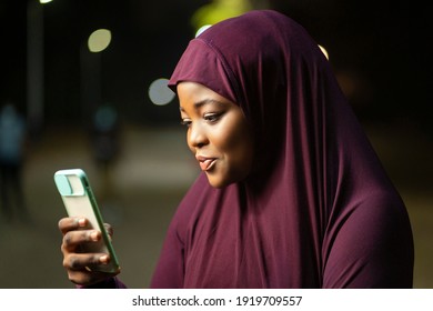 Image Of Traditional  African Woman With A Smart Phone- Local Muslim Lady Surfing On Social Media- Outdoor Communication Concept