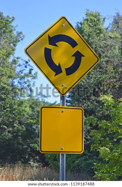 Image of a traffic circle warning\
sign, can be symbolic of life choice, decisions and\
reversals