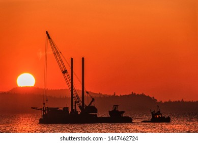 Image Of A Tug Boat Towing A Barge With A Crane Onboard At Sunset, Vancouver Island, BC, Canada