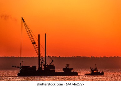 Image Of A Tug Boat Towing A Barge With A Crane Onboard At Sunset, Vancouver Island, BC, Canada