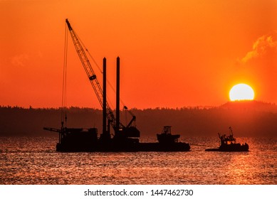 Image Of A Tug Boat Towing A Barge With A Crane Onboard At Sunset, Vancouver Island, BC, Canada