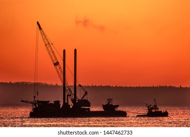 Image Of A Tug Boat Towing A Barge With A Crane Onboard At Sunset, Vancouver Island, BC, Canada