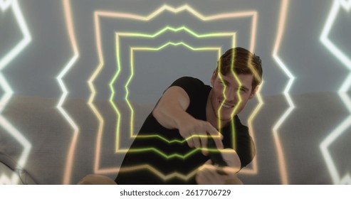 Image of tunnel with neon shapes over caucasian man playing image games. global technology, social media and digital interface concept digitally generated image. - Powered by Shutterstock - Get 15% off with code: PIKWIZARD15