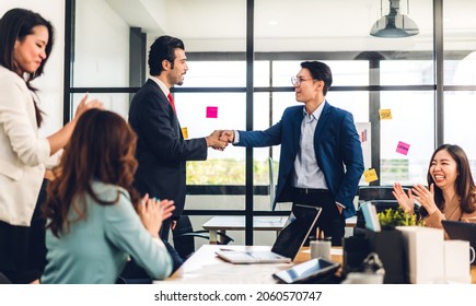 Image Two Asian Business Partners Successful Handshake Together In Front Of Group Teamwork Casual Business Clapping Hands Winning Success Agreement In Modern Office.Partnership Approval And Teamwork