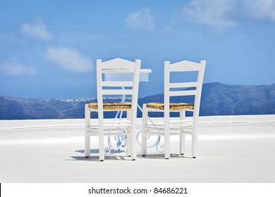 An image of two chairs in the sun