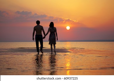 The image of two people in love at sunset