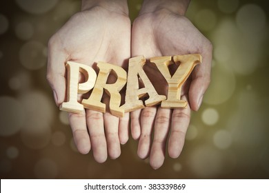 Image Of Two Prayer Hands Holding A Word Of Pray With Bokeh Background