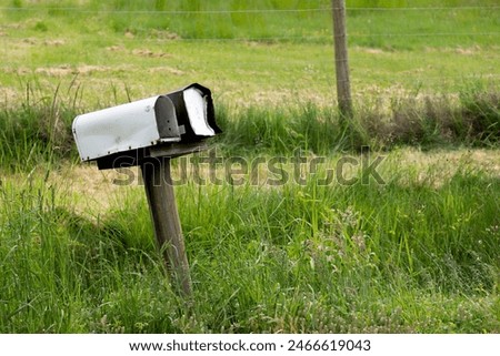 An image of two rural postal boxes on the side of an old country road. 