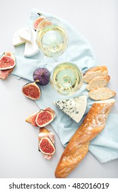 image of two wine glasses and snacks