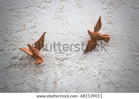 the image two wooden figures of doves