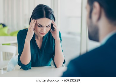 Image of two workers at a meeting in a restaurant. Young pretty exhausted businesswoman having headache because of problems at work. - Shutterstock ID 609132929