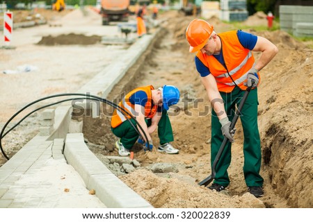 Image of two workers on a road construction