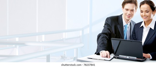 Image Of Two Working People Looking At Laptop Screen In Office