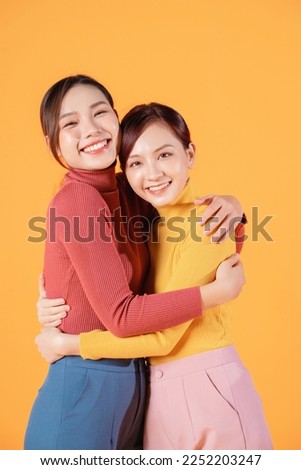 Image of two young Asian woman on background