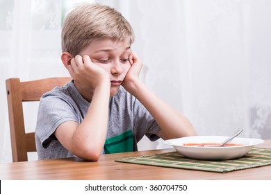 Image Of Unhappy Fussy Eater During Dinner