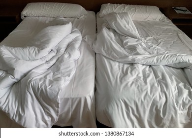 Image Of Unmade Double Bed In A Hotel Room