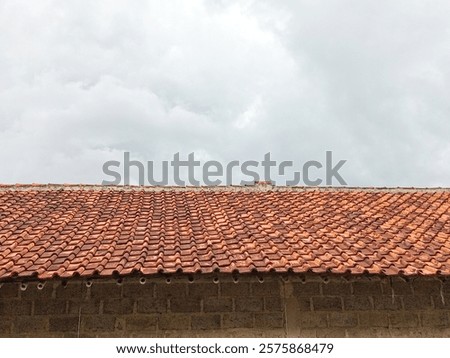 an image of view of black clouds above the roof of the house 