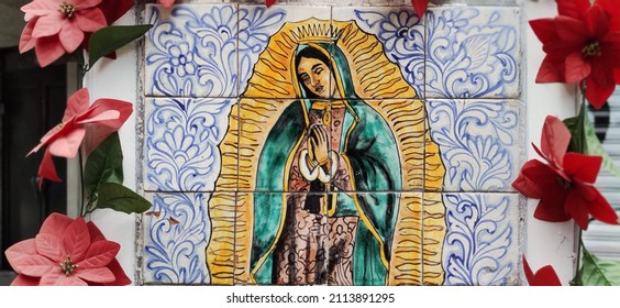 Image of the Virgin of Guadalupe embodied on tiles, with flowers around