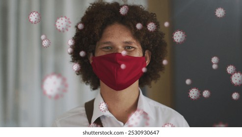 Image of virus cells over biracial man with face mask. social media and communication interface during covid 19 pandemic concept digitally generated image. - Powered by Shutterstock