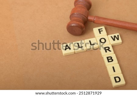 The image visually represents the contrast between allowing and forbidding, with the letters forming the words "ALLOW" and "FORBID" arranged in a conflicting manner.