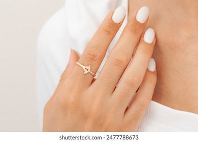 An image with well-groomed nails and jewelry concept. Female model shows a gold elegant ring on her finger. Jewelry photography for e-commerce, social media and all platforms. - Powered by Shutterstock