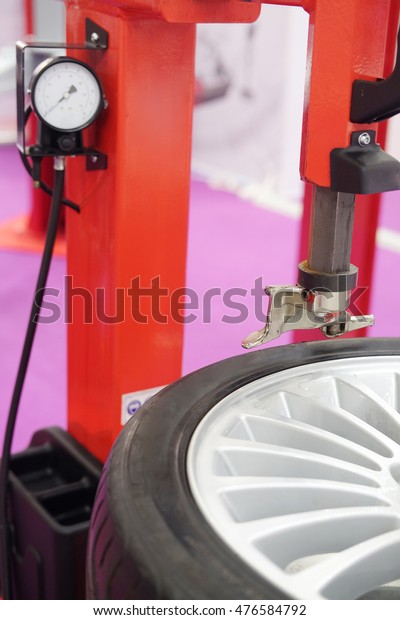 The image of a wheel\
on a tire machine