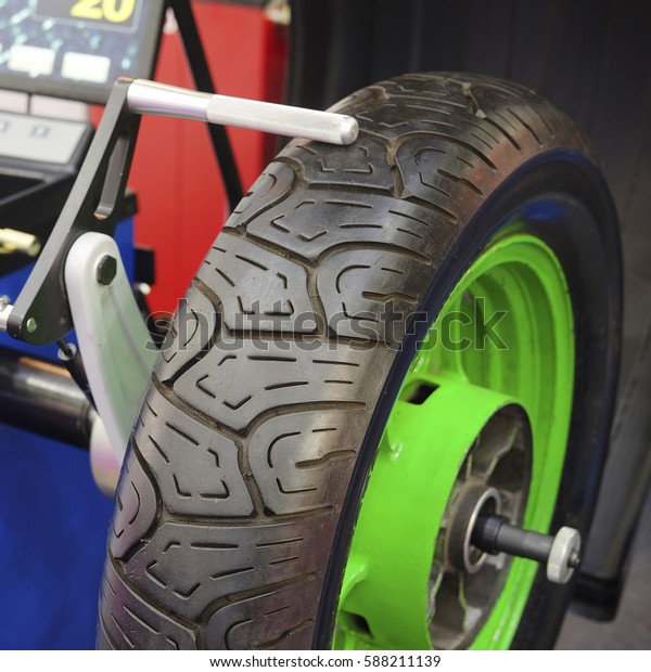 The image of a wheel\
on a tire machine