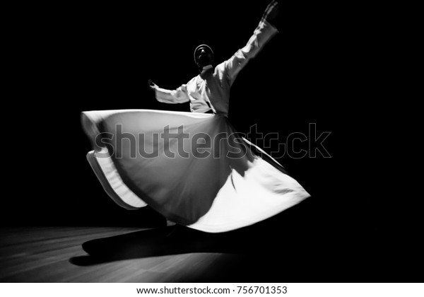the image of\
a whirling Dervish in the\
darkness