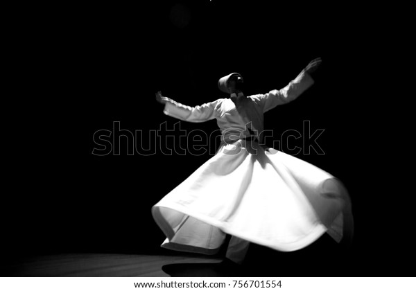 the image of\
a whirling Dervish in the\
darkness