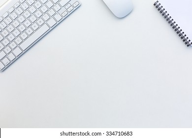 Image Of White Office Desk With Computer Keyboard Mouse And Notepad From Above