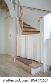 Image Of White Plastic Child Safety Gate On The Wooden Stairs