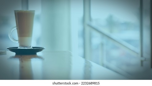 Image of a white QR code scanning over a cup of caffe latte standing on a table in a cafe. Digital composite image