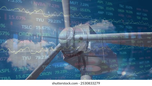 The image of a wind turbine on a sky background represents the global data processing concept of the stock market. The numbers and graphs on the screen represent the prices of stocks, which are - Powered by Shutterstock