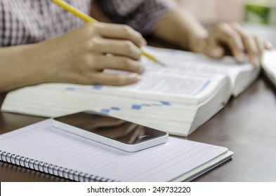 Image Of Woman Checking A Term In A Dictionary