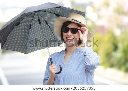 Image of a woman holding a parasol 
