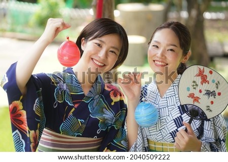 Image of a woman holding a water balloon 