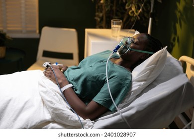 Image of a woman in a hospital ward, African, with an oxygen mask, recuperating after episode of breathing difficulties. - Powered by Shutterstock