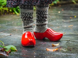 Image Of Woman Legs In Woolen Socks And Traditional Wooden Clogs, Seasonal Clothes, Outdoors Image.
