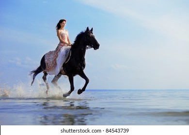 Image of a woman on a horse by the sea