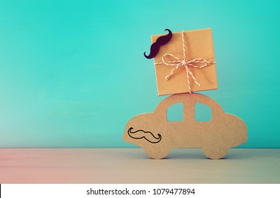 Image Of Wooden Car With Gift Box On The Roof, Present For Dad. Father's Day Concept