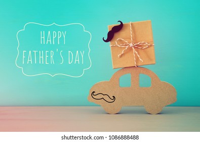 Image Of Wooden Car With Gift Box On The Roof, Present For Dad. Father's Day Concept