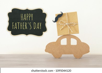 Image of wooden car with gift box on the roof, present for dad. Father's day concept - Powered by Shutterstock