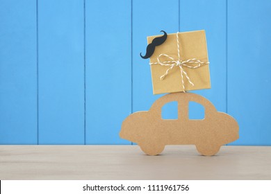 Image Of Wooden Car With Gift Box On The Roof, Present For Dad. Father's Day Concept