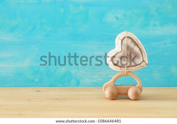 Image of wooden car with heart on the roof,\
present for dad. Father\'s day\
concept