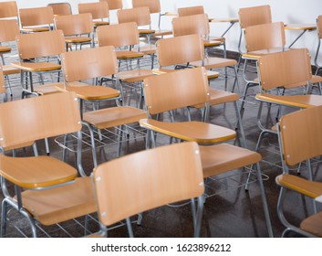 Image Of Wooden Chairs In Rows In Classroom Of School Interior, No People

