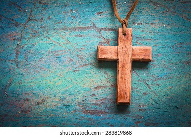 Image of wooden cross on blue retro background