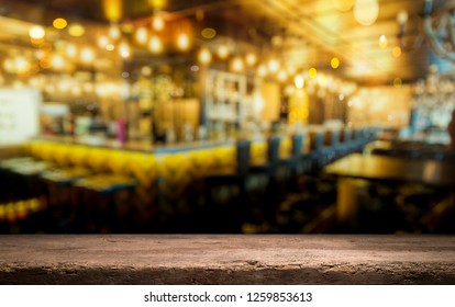 Image Of Wooden Table In Front Of Abstract Blurred Background Of Resturant Lights