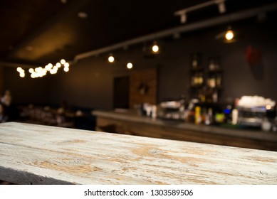 Image Of Wooden Table In Front Of Abstract Blurred Background Of Resturant Lights